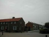 Rechthoekige verkavelingsstructuur en gladde, sobere gevelwanden.