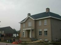 Architectonische vormgeving met gebruik van klassieke elementen, zoals middenrisaliet en zuilen.